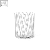 A sleek cylindrical wire candle holder with interlocking metal rods and flat base in brushed stainless steel