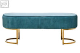 Teal green velvet ottoman bench with gold finish curved metal legs and soft corduroy upholstery