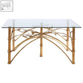 Golden zariah table with bamboo design legs and a clear glass top perfect for stylish indoor spaces
