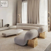 Modern zeita lounge chair with curved gray fabric upholstery and sleek gold cube base for stylish comfort