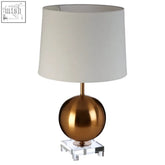 Zena gold sphere table lamp with a sleek brass sphere base and clear acrylic square pedestal with white shade