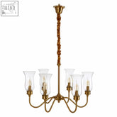 Zissi ceiling light with gold ceiling tones, eight clear glass shades, and twisted brass stem for stylish lighting