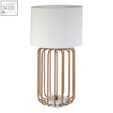 Zora gold caged table lamp with a white cylindrical shade and a stylish gold metal cage design