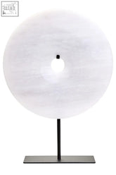 A sleek zoro medium round table lamp with a grey marble disc and minimalist black metal stand