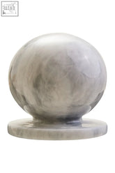 A polished gray and white marble ball sculpture with swirling veining resting on a matching circular base