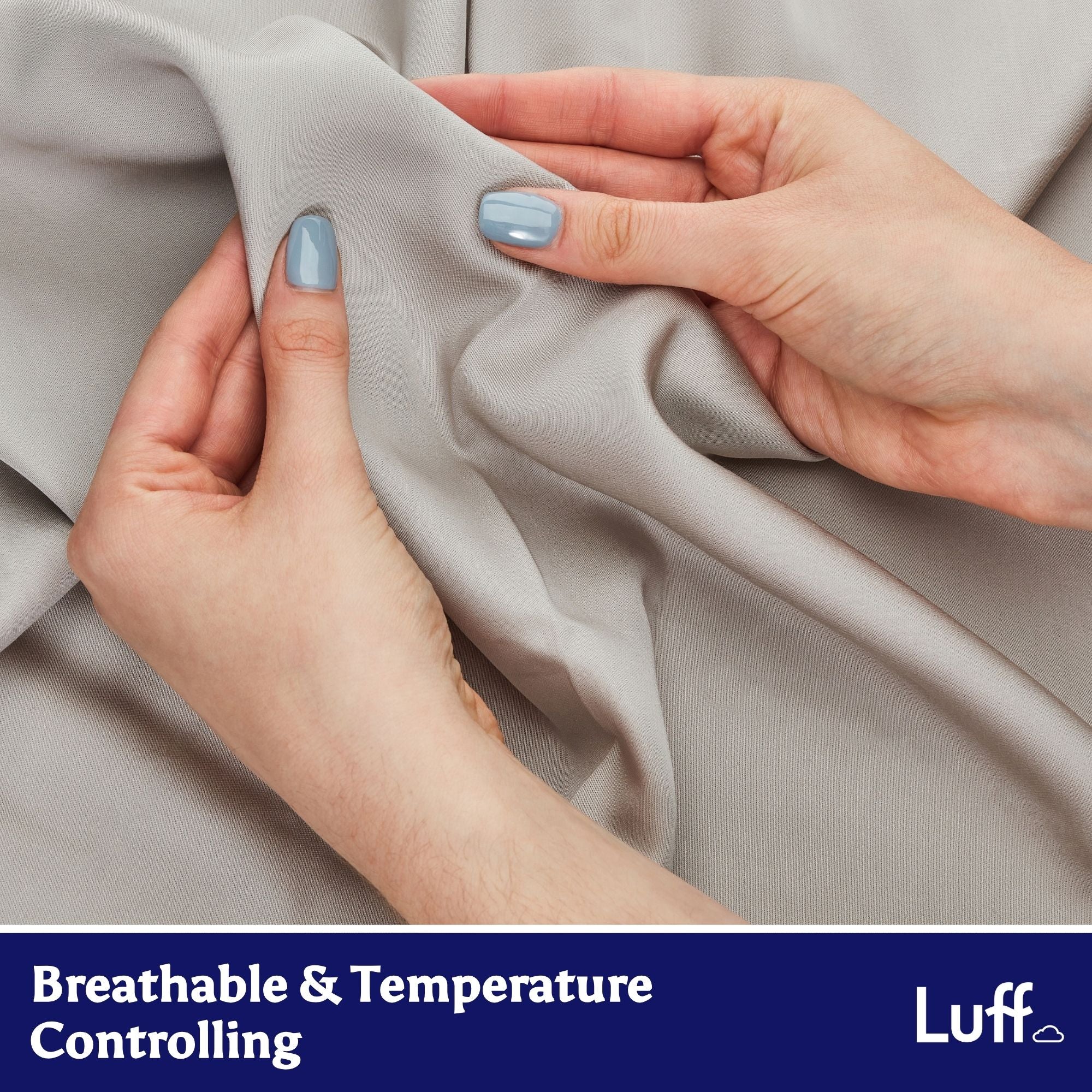 Light gray 100% organic bamboo flat bed sheets with smooth texture gently held by hands with light blue nail polish