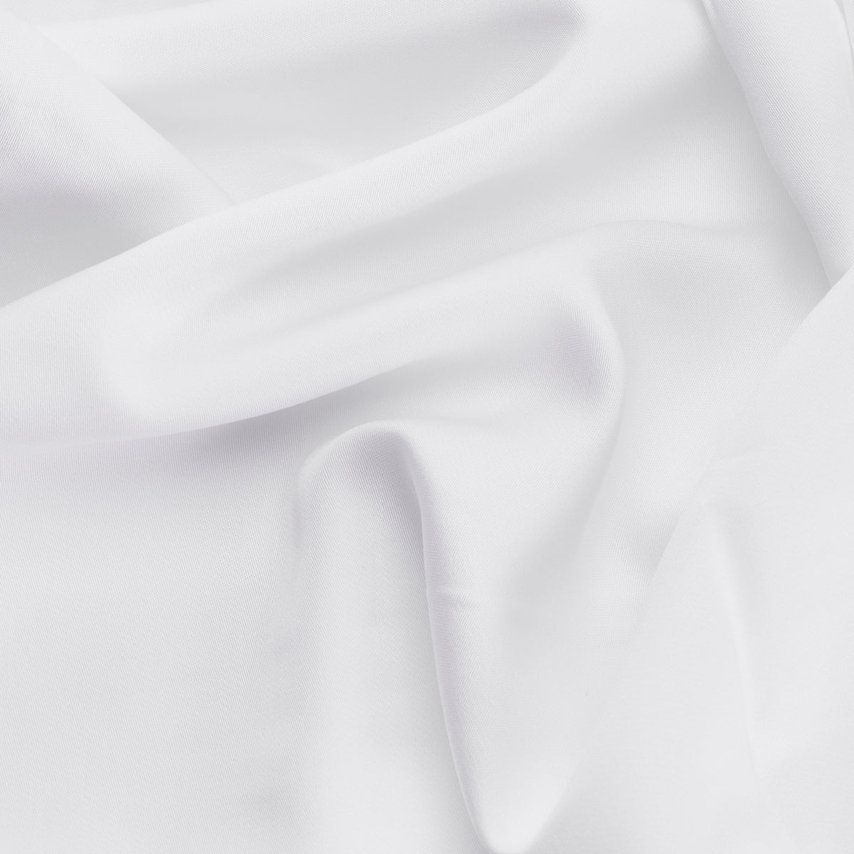 White smooth organic bamboo flat bed sheets with subtle sheen and gentle folds for cozy sleep