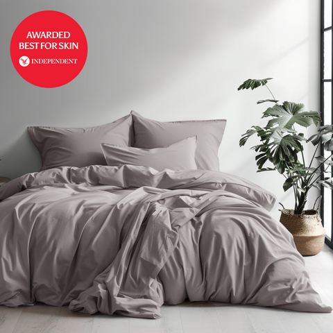 A soft muted gray 100 percent organic bamboo silk duvet cover set with matching pillows and relaxed rumpled texture