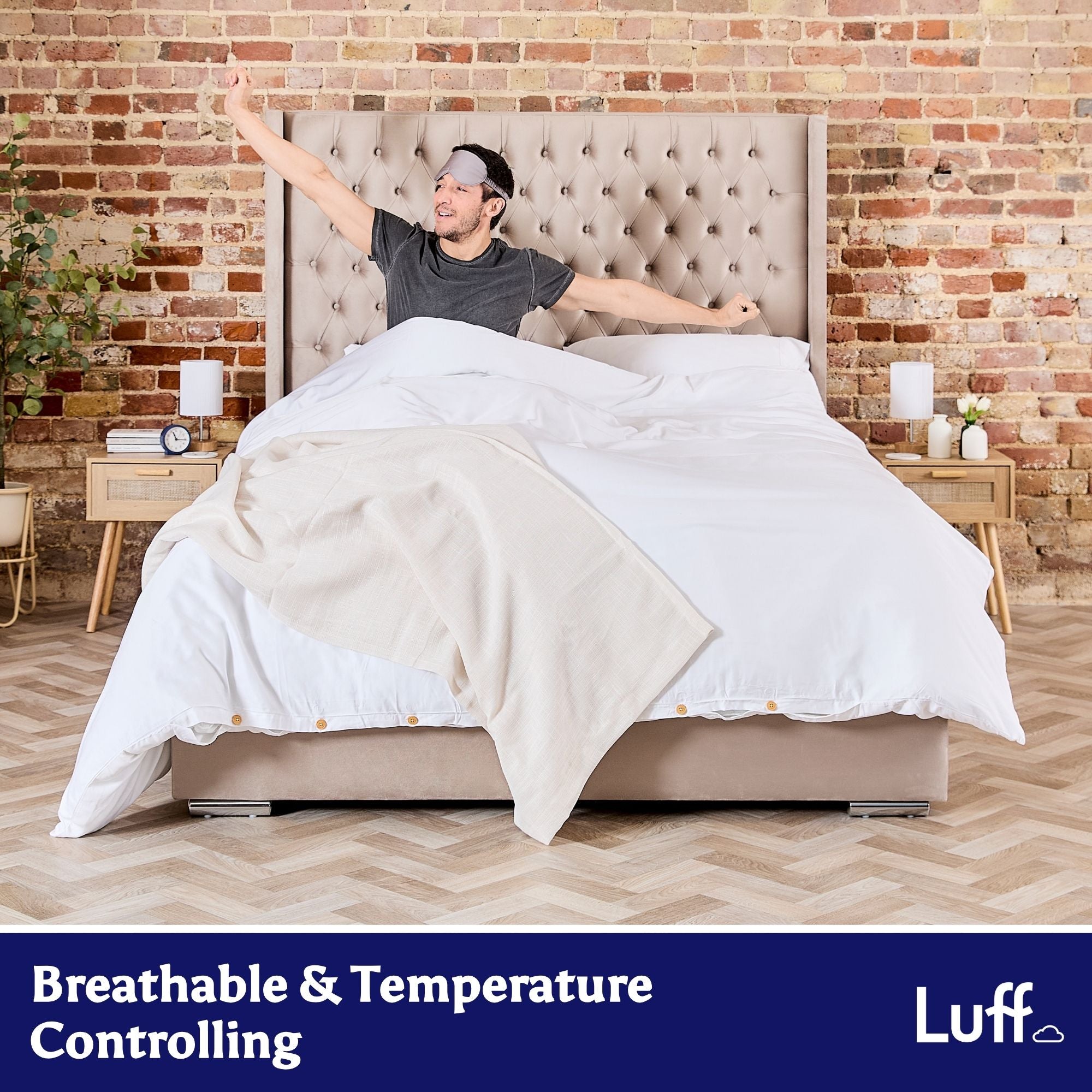 Beige tufted bed with a man wearing a sleep mask lying on a 100% organic bamboo silk duvet cover set