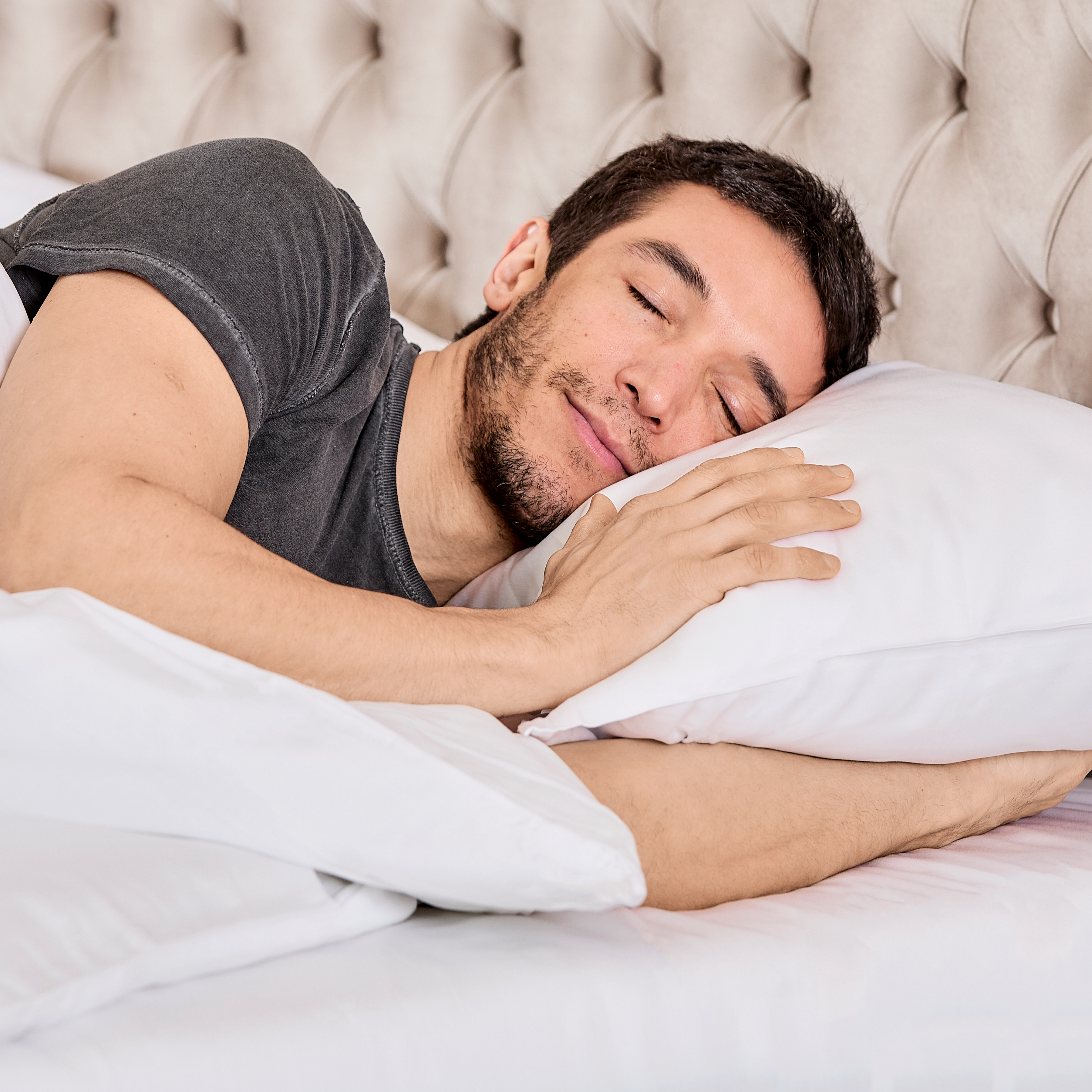 Man sleeping on white pillow with 100% organic bamboo silk duvet cover in soft white color