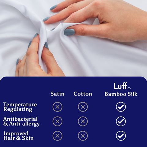A soft white luff bamboo silk duvet cover gently stretched by hands with teal nail polish showing fabric quality