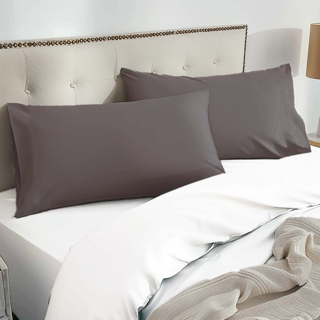 Two dark gray 100% organic bamboo silk pillowcases with a smooth satin finish resting neatly on the bed
