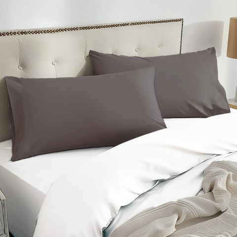 Two dark gray 100% organic bamboo silk pillowcases with a smooth satin finish resting neatly on the bed