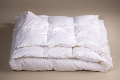 White quilted down comforter with soft plush texture and subtle stitching made from goose feather for winter use