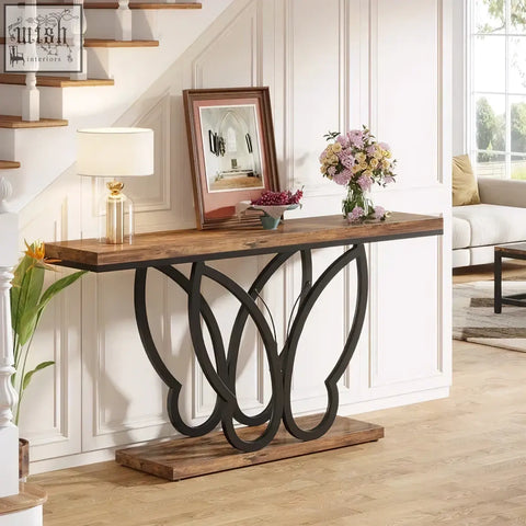 Rustic wooden console table with black butterfly metal frame legs featuring an intricate flowing design
