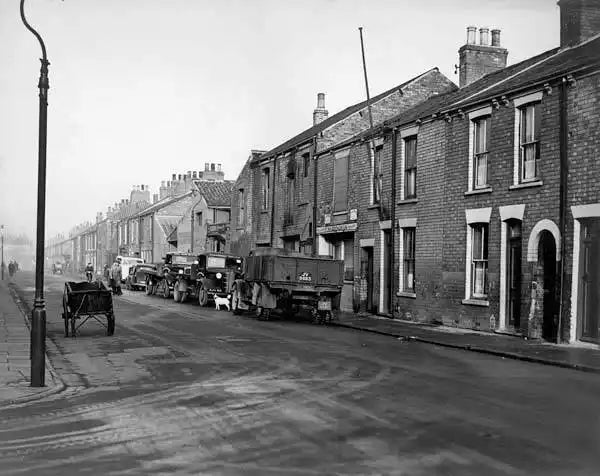 1930s-style brick row houses with wooden doors and windows.