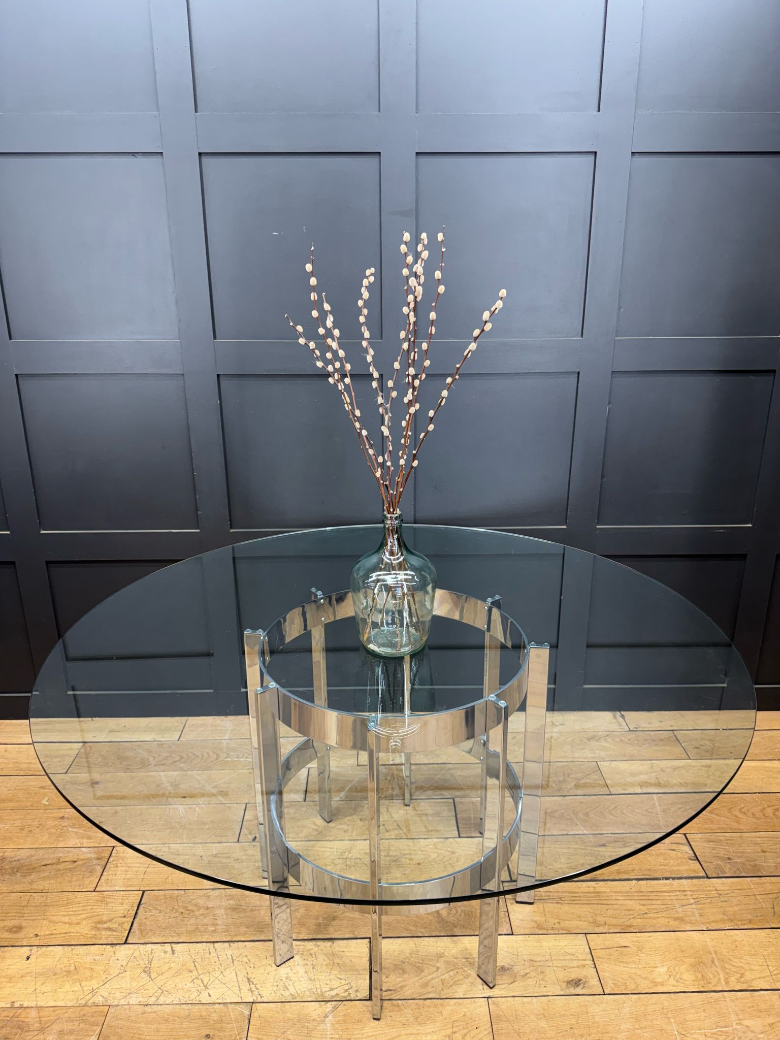 Modern round glass dining table with sleek chrome frame by richard young merrow associates from the 1970s