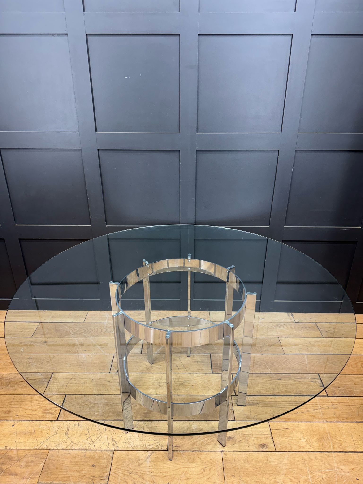 Modern chrome dining table by richard young merrow associates with clear glass top and tiered metal base