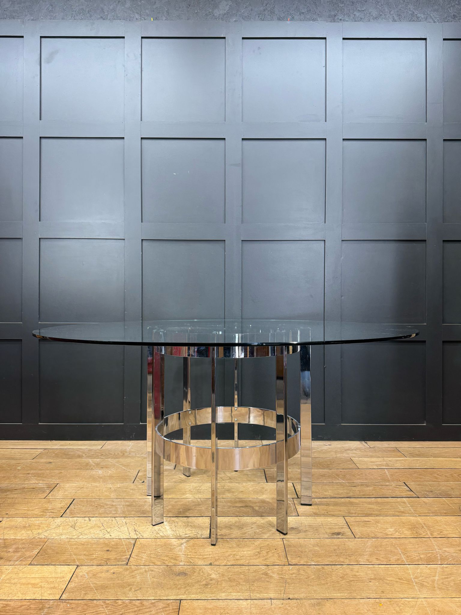 Modern chrome dining table by richard young merrow associates with round glass top and geometric base