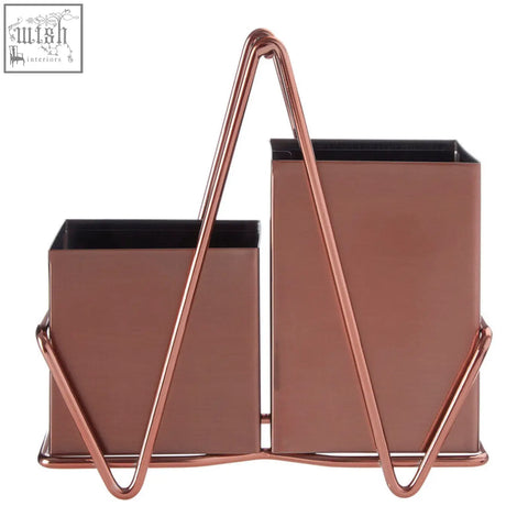 Rose gold metal desk organizer with two rectangular compartments and a triangular handle for rose gold cutlery caddy use