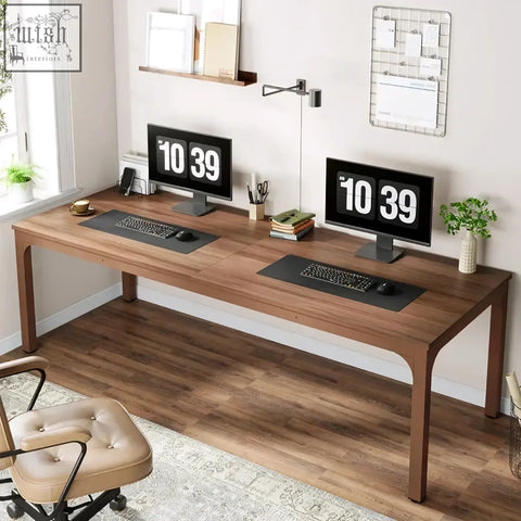 Long walnut extra long desk with two monitors keyboards and mice perfect for large home office workstation