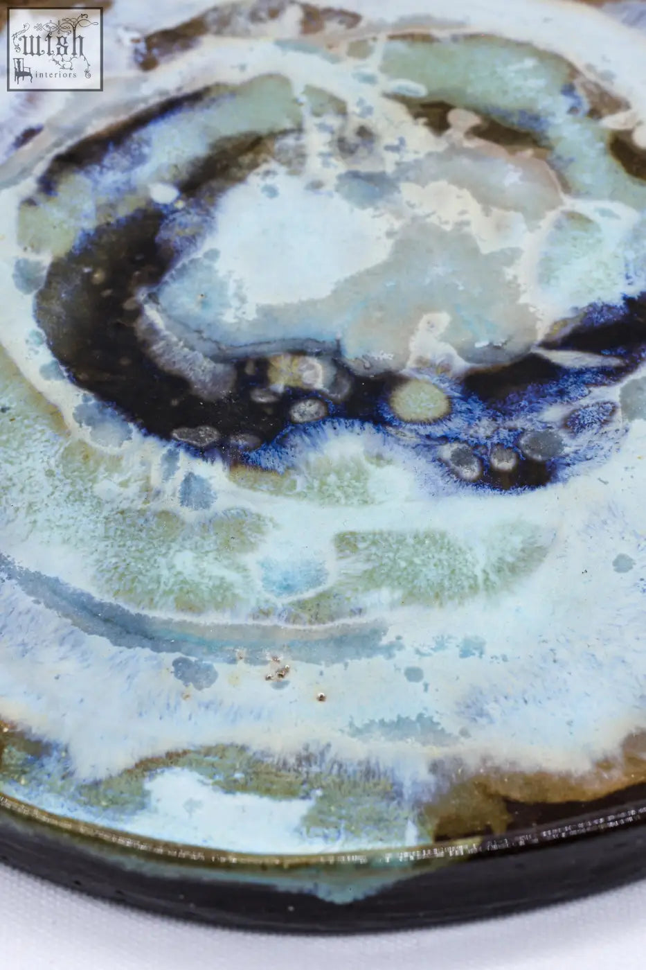 A 23 cm smoked grey large stoneware handmade ceramic dinner plate with a swirling blue green and white abstract glaze