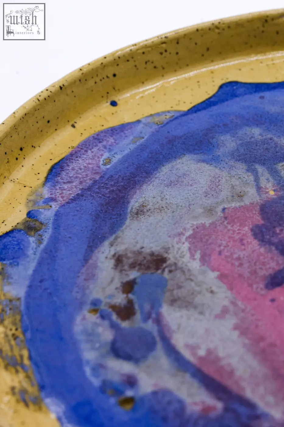 A 23 cm deepsea stoneware handmade ceramic dinner plate with a speckled yellow rim and vibrant blue purple pink glaze