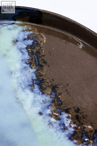 A 23 cm seabrook smoked grey large stoneware handmade ceramic dinner plate with glossy dark brown glaze and blue green accents