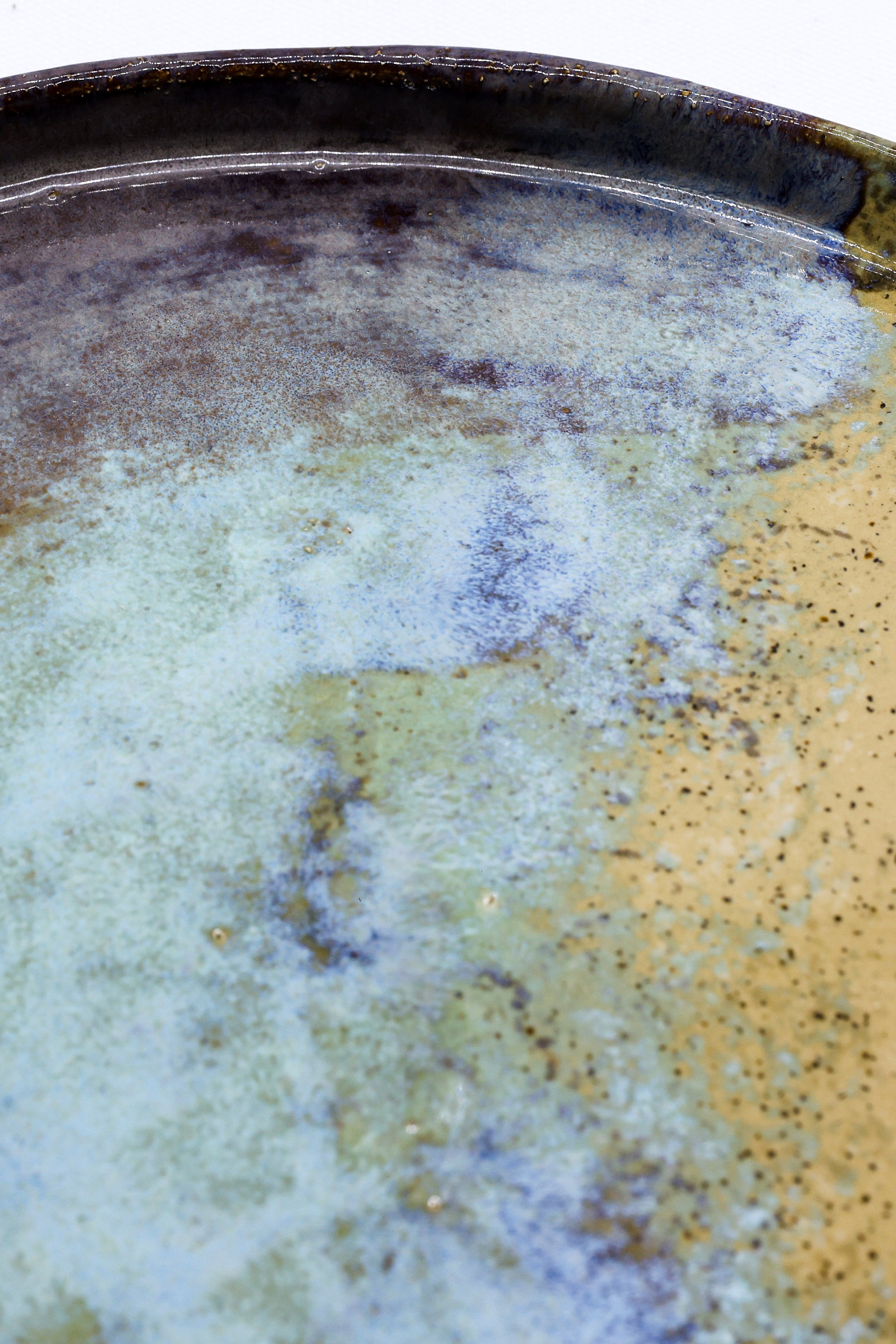 A 27 cm shoreline stoneware handmade ceramic dinner plate with glossy blue green and amber mottled glaze from ribera handmade ceramics