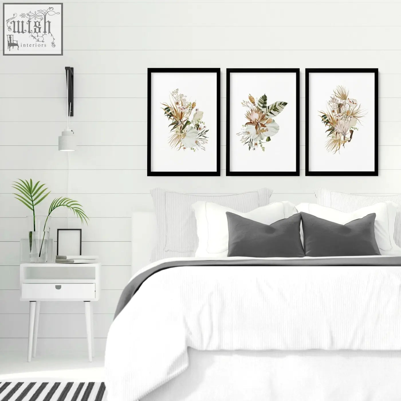 Three black-framed botanical wall art prints featuring delicate dried flowers perfect as framed wall art above bed