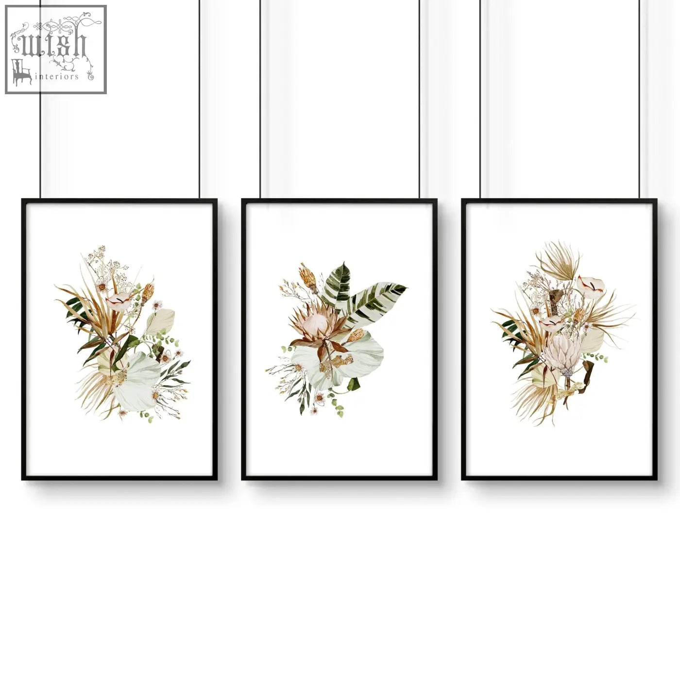 Set of 3 framed wall art featuring black frames and delicate beige and green botanical art prints above bed