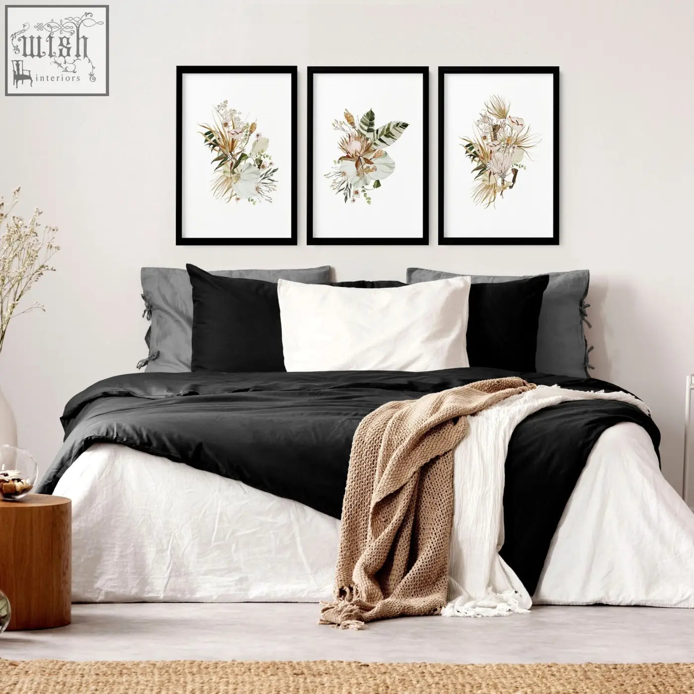 Set of 3 framed wall art featuring delicate dried flower art prints in black frames above bed as stylish wall art