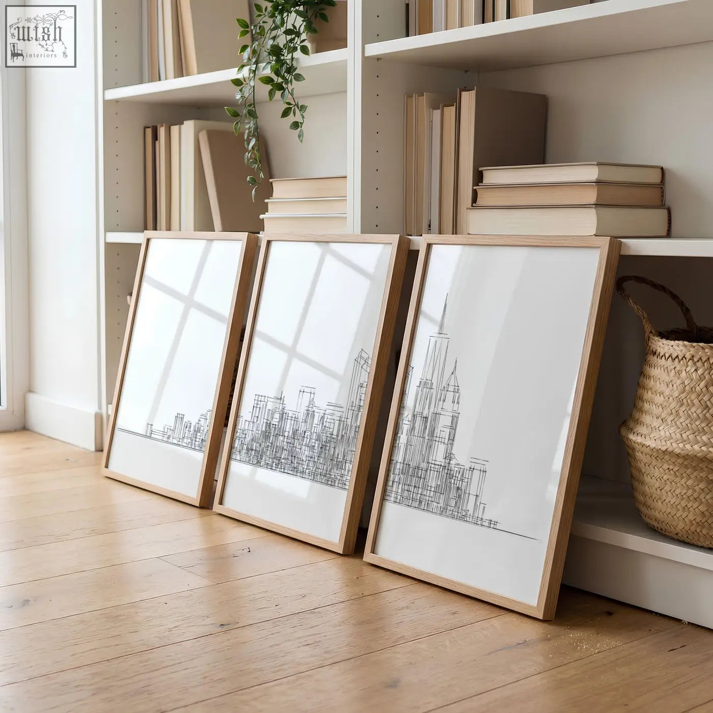 Three framed living room wall art prints with minimalist black new york skyline line drawings in light wood frames