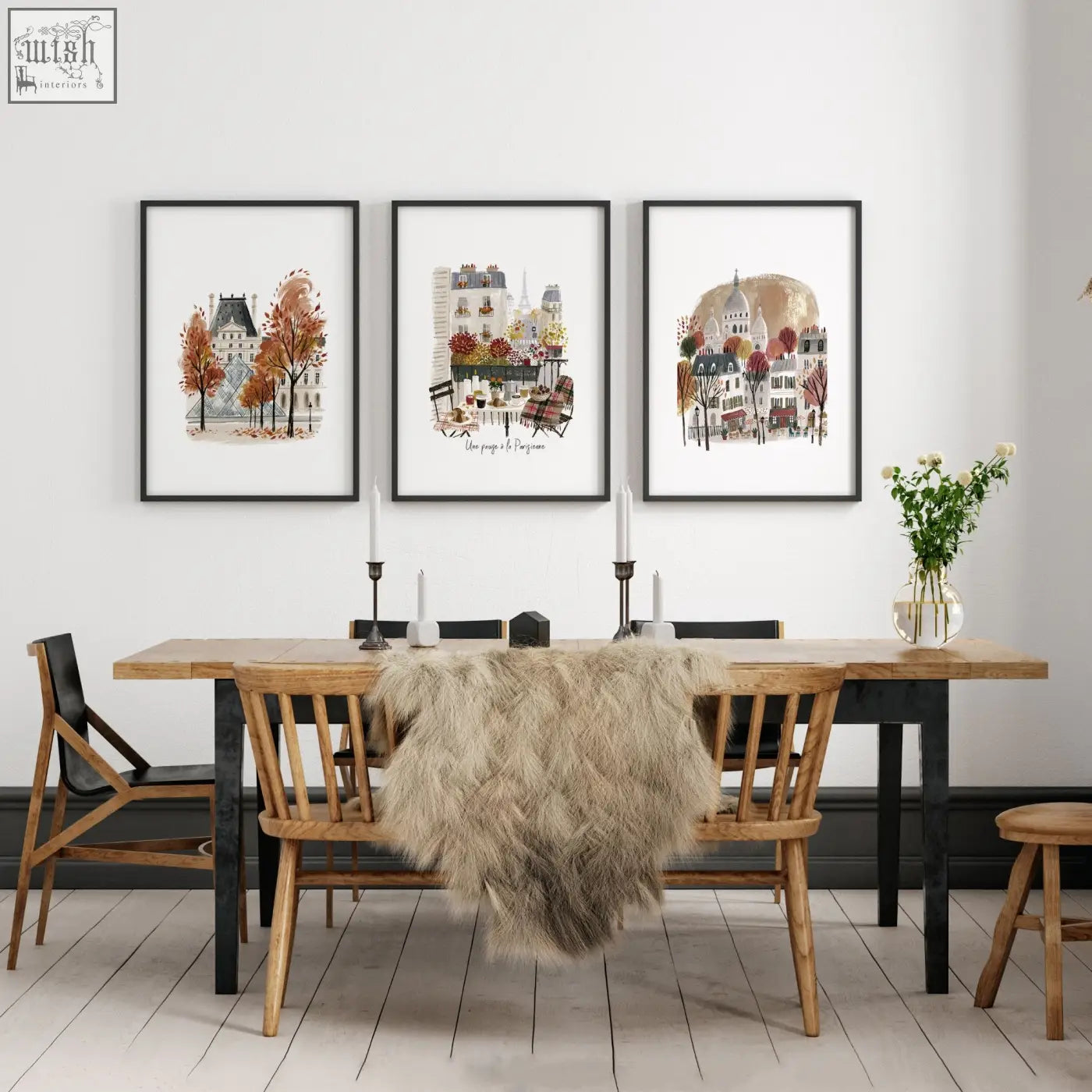 Three framed parisian art prints featuring eiffel tower hang above wooden dining room table for travel decor