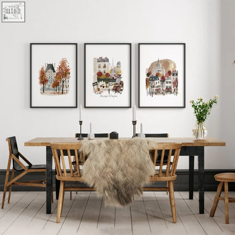 Three framed parisian art prints featuring eiffel tower hang above wooden dining room table for travel decor