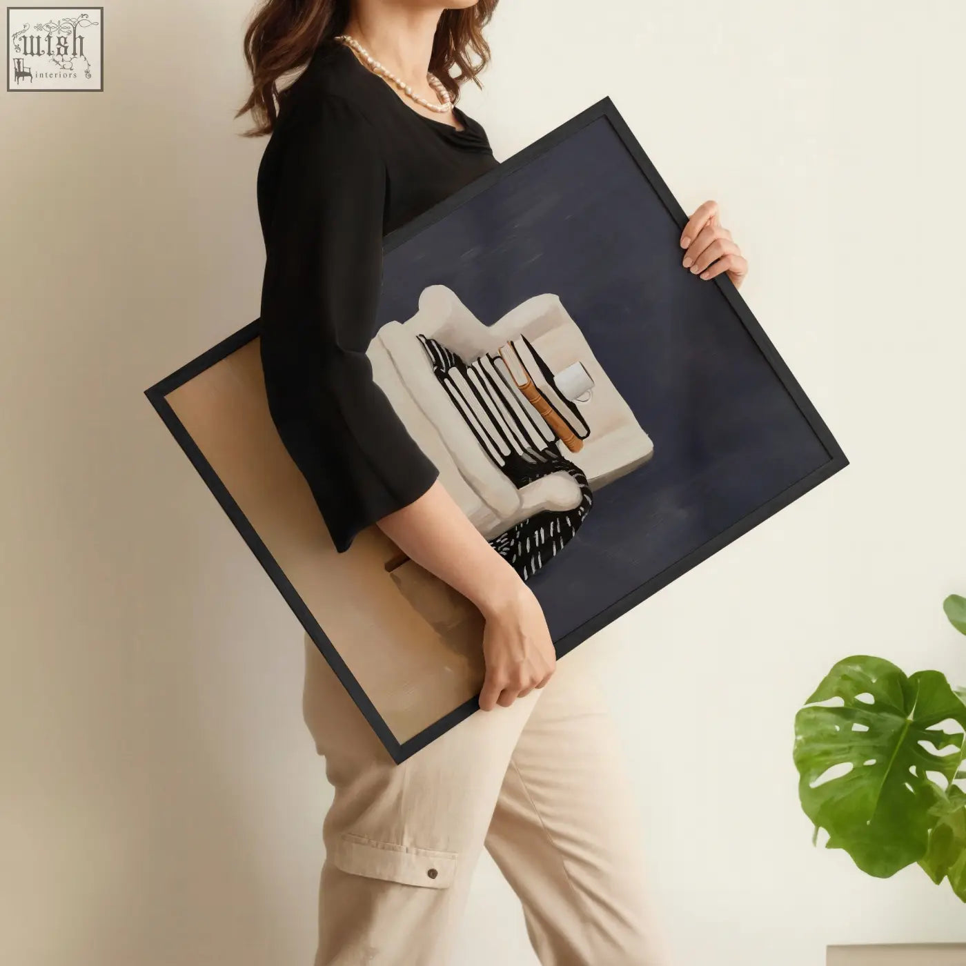 Black-framed canvas wall art framed showing minimalist still life with white ceramicware and striped textiles on navy background