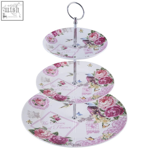 Three tiered porcelain cake stands with lilac lavender rose bird butterfly design on white plates with silver pole