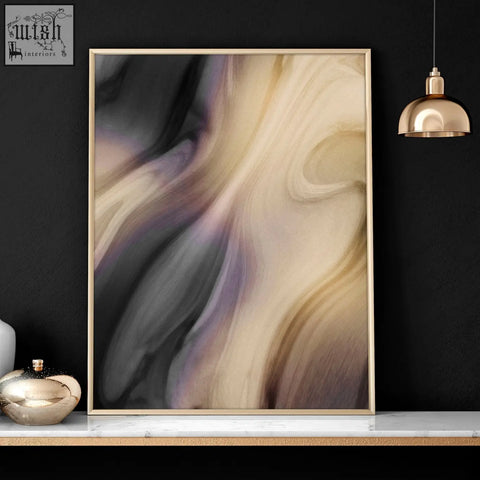 A contemporary wall art set featuring a modern abstract print with beige black and muted purple in a gold frame