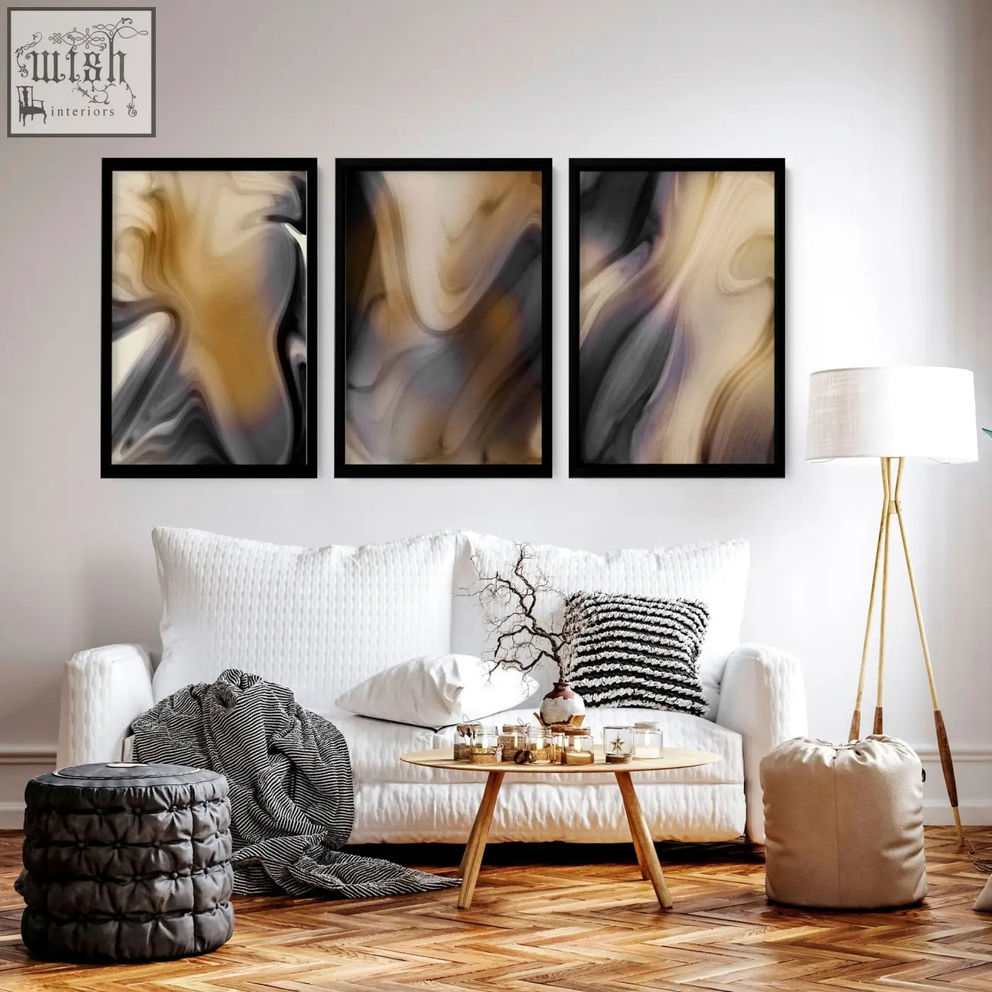 Three framed contemporary wall art set with swirling beige gray and black patterns hangs above a white sofa