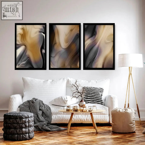 Three framed contemporary wall art set with swirling beige gray and black patterns hangs above a white sofa