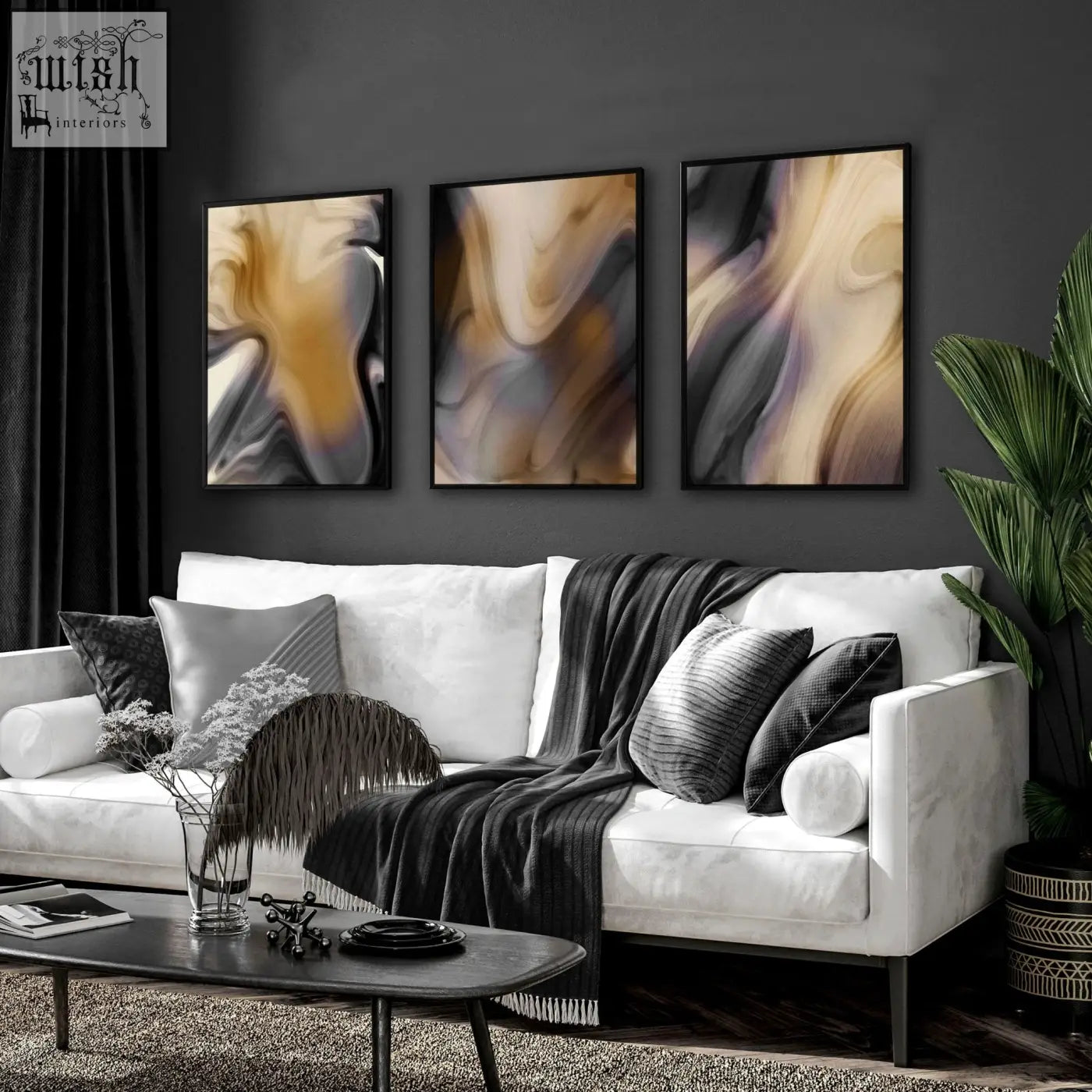 White leather sofa with black and gray pillows and dark gray knit blanket near a contemporary wall art set on wall
