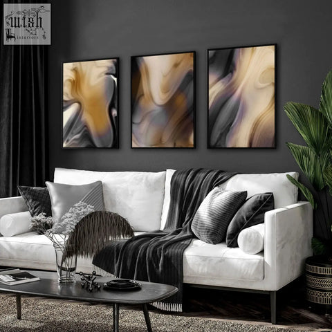 White leather sofa with black and gray pillows and dark gray knit blanket near a contemporary wall art set on wall