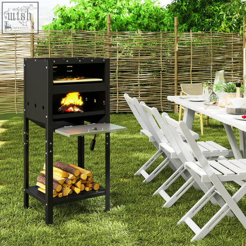 Black metal outdoor pizza oven with fire and stacked logs below featuring oxford cloth cover in black finish