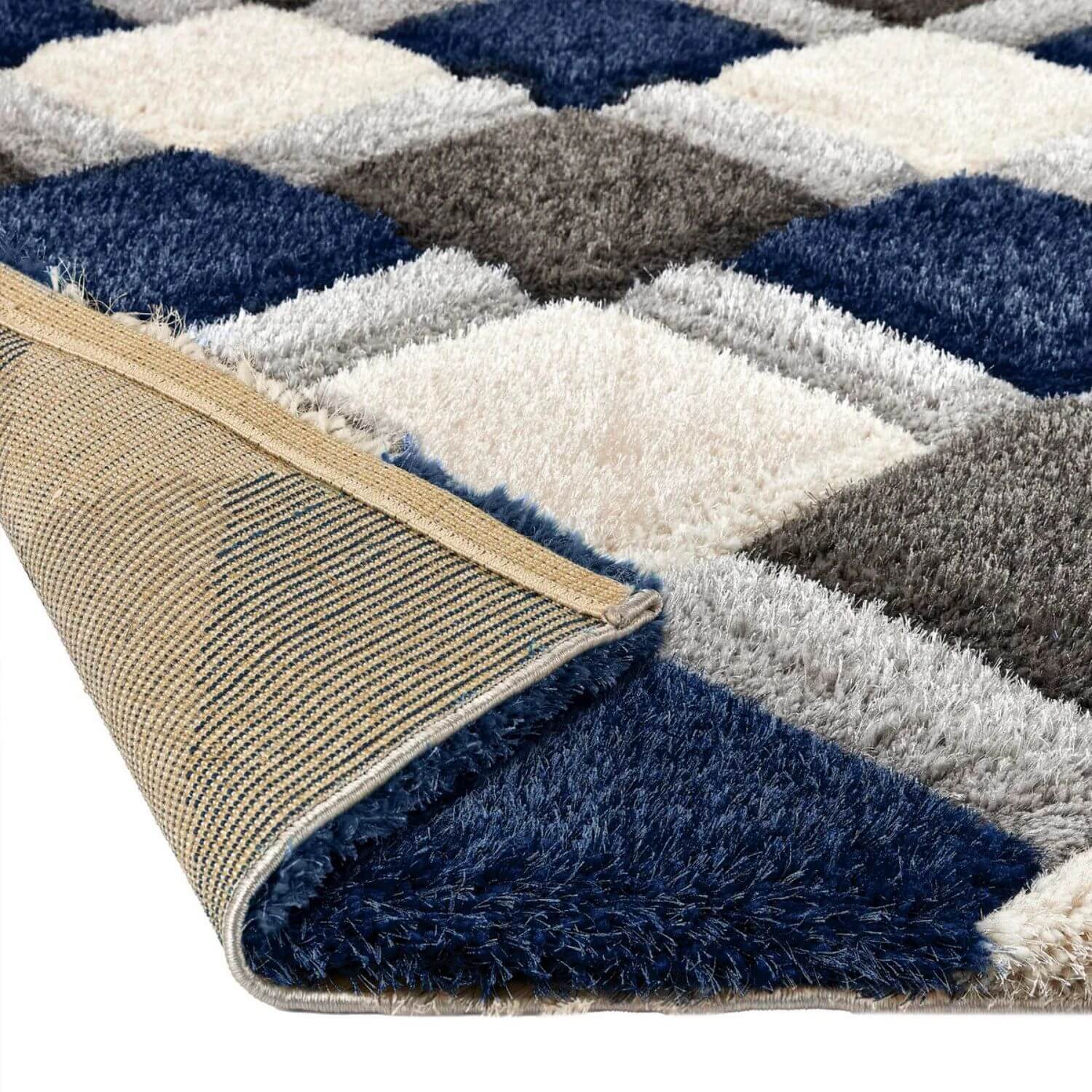 A plush navy geometric shaggy rug with a 3d geometric pattern in navy blue white and gray tones