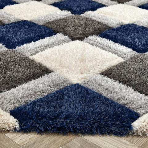 A plush navy geometric shaggy rug with a 3d diamond pattern in navy blue cream white and gray