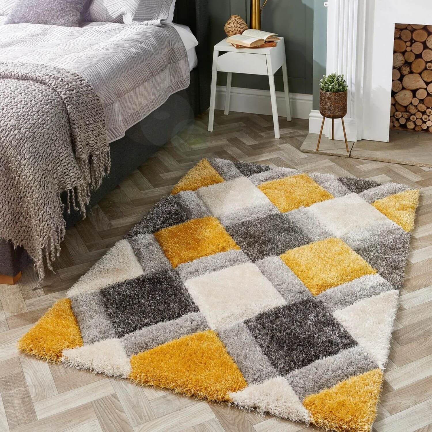 A plush ochre geometric shaggy area rug with a 3d patchwork design in mustard yellow gray and cream colors