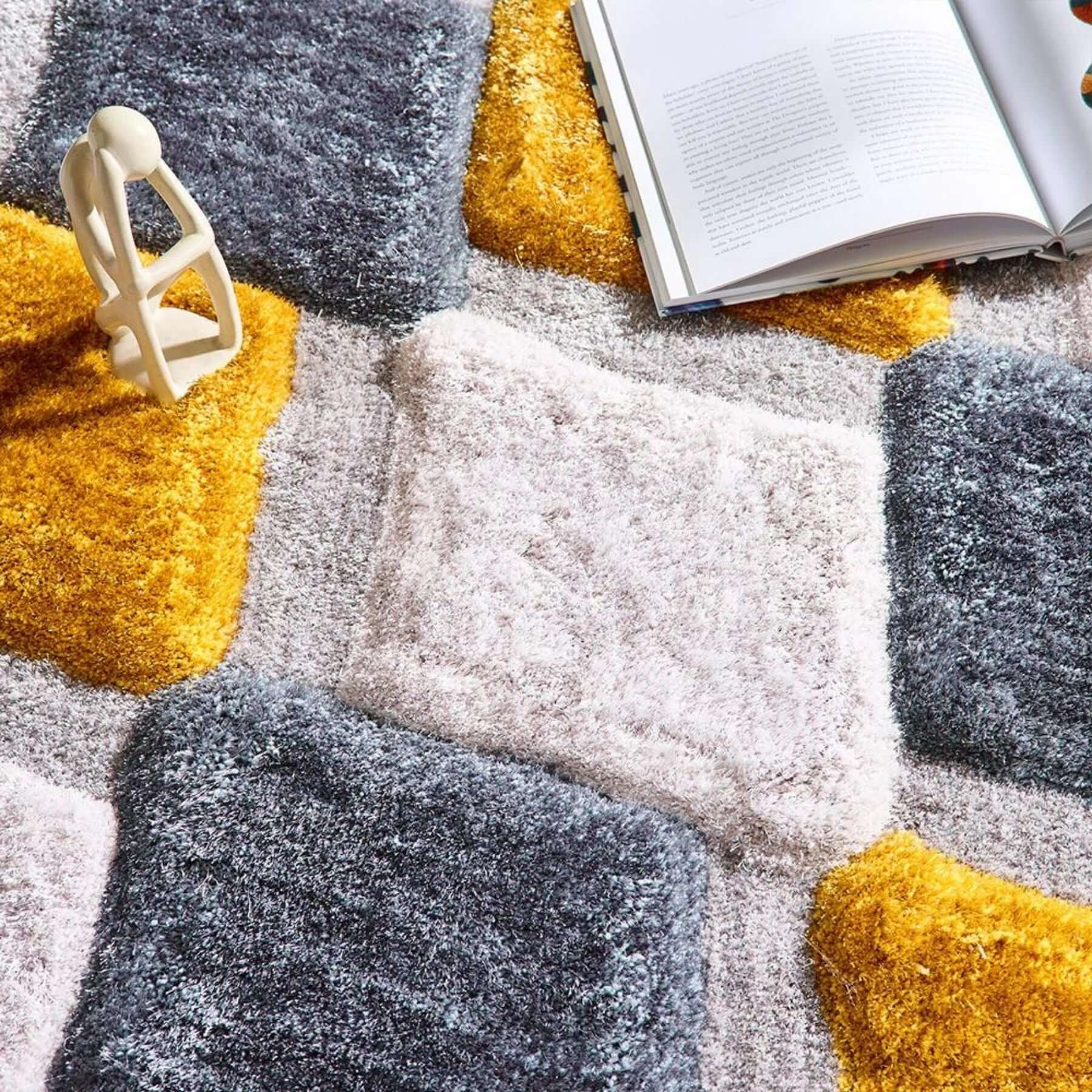 A plush modern 3d ochre geometric shaggy rug with gray white and mustard yellow geometric patchwork design