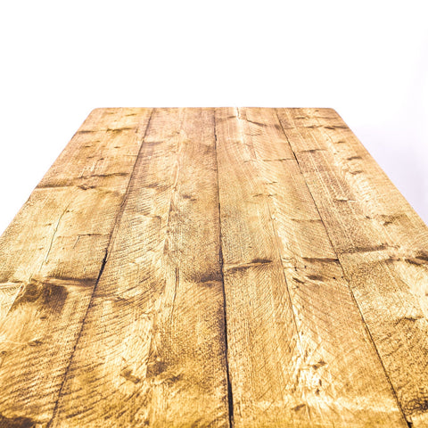 A rustic light brown wooden dining table with rose gold steel legs perfect for 4-8 seater setups and furniture care kit use