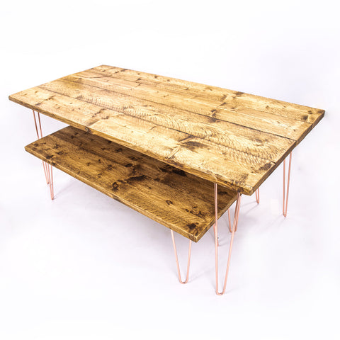 Reclaimed wood two-tier coffee table with copper hairpin legs shown with rose gold steel dining table and benches ideal for furniture care kit use