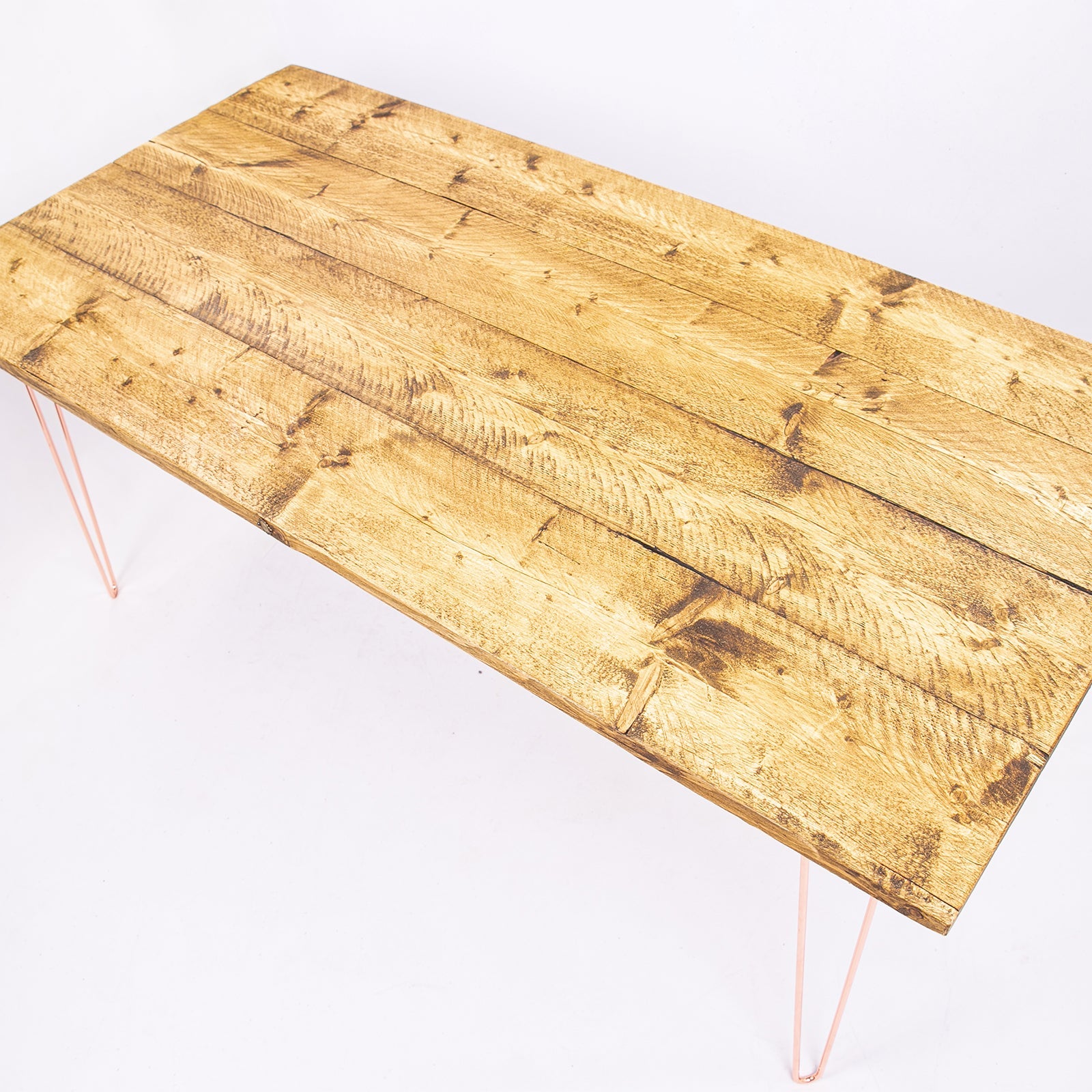 Rustic light golden-brown reclaimed wood dining table with slender rose gold steel hairpin legs perfect for 4-8 seats
